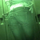 A woman is observed taking a piss and a hard, chunky shit into a portable toilet from a hole-in-the-wall perspective with low light vision equipment. Presented in 720P HD. Over 2.5 minutes.